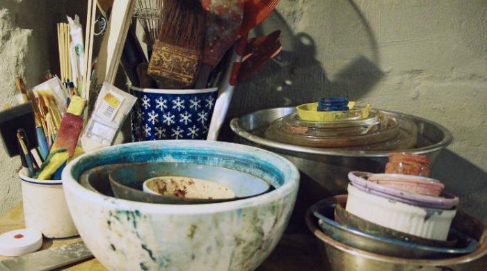 A collection of bowls and brushes used to make dye.