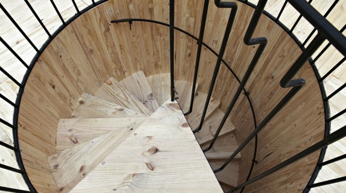 A wooden spiral staircase at the Royal Academy of the Arts.
