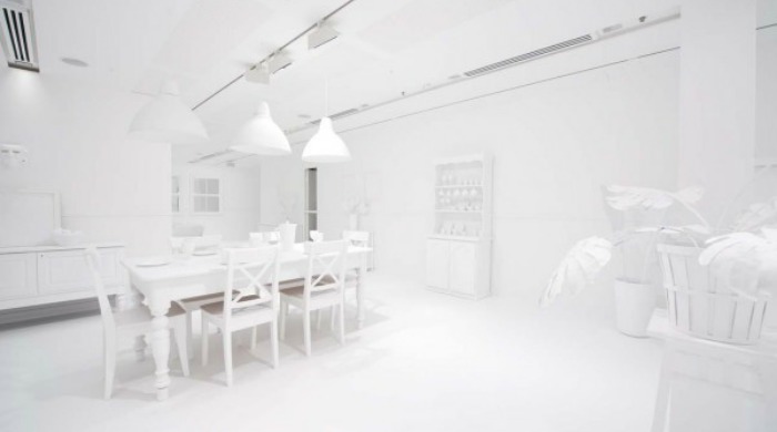 The white Obliteration Room at the beginning of the project by Yayoi Kusama.