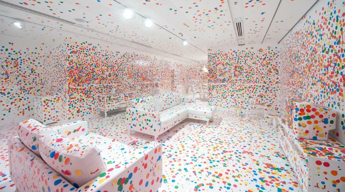 The Obliteration Room with colourful stickers covering most of it by Yayoi Kusama.