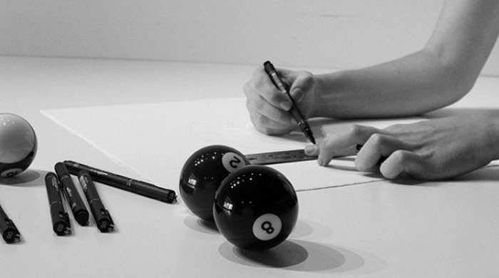 CJ Hendry drawing with a ruler next to some snooker balls.
