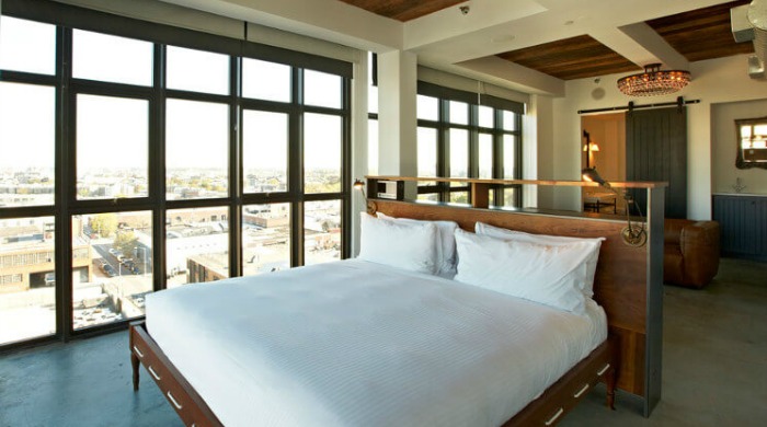 A room in the Wythe Hotel, Brooklyn with large grid windows.