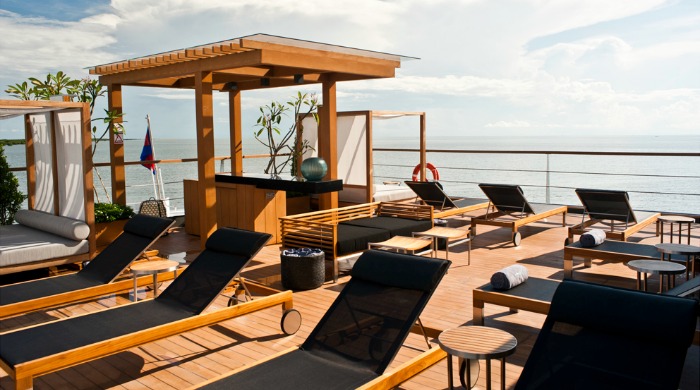 The deck of the Aqua Mekong cruise ship with sun loungers.