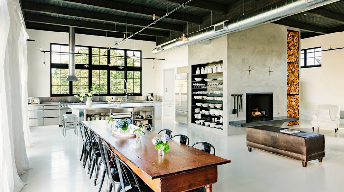 An open plan industrial Portland loft with wooden furniture accents.