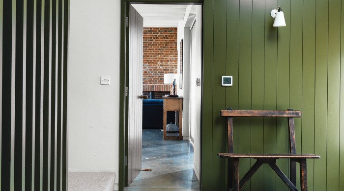The inside of Lucy Marston's Suffolk farmhouse with green panelled wood features.