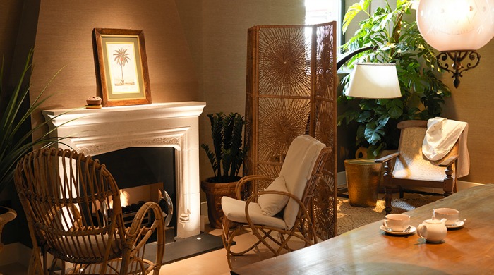 A seating area with a fireplace in The South Kensington Club.