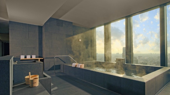A hot bath pool with views over the city in Aman Tokyo.