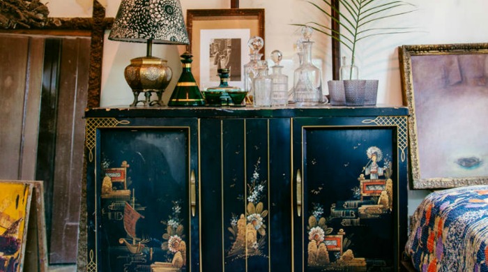 An ornate black cabinet from the modern bohemia trend.