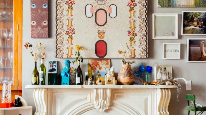 A cream mantlepiece covered with colourful ornaments from the modern bohemia trend.