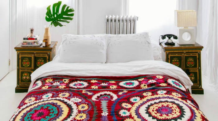 A bed with a colourful bedspread from the modern bohemia trend.