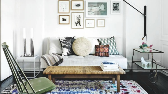 A white living room with a large, patterned rug from Apartment Therapy.