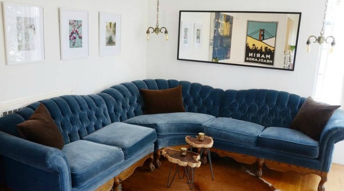 A white living room with a blue corner sofa from Apartment Therapy.