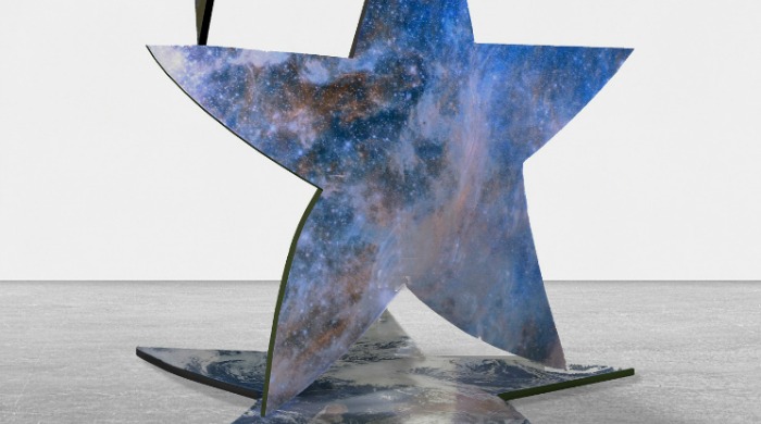 A metal sculpture made up of stars with a galaxy print by Andrew Levitas.